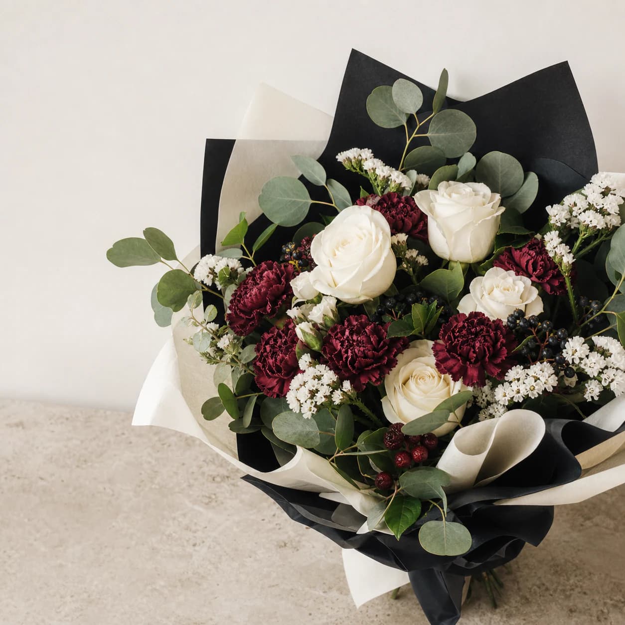 White and burgundy bouquet with eucalyptus and berries