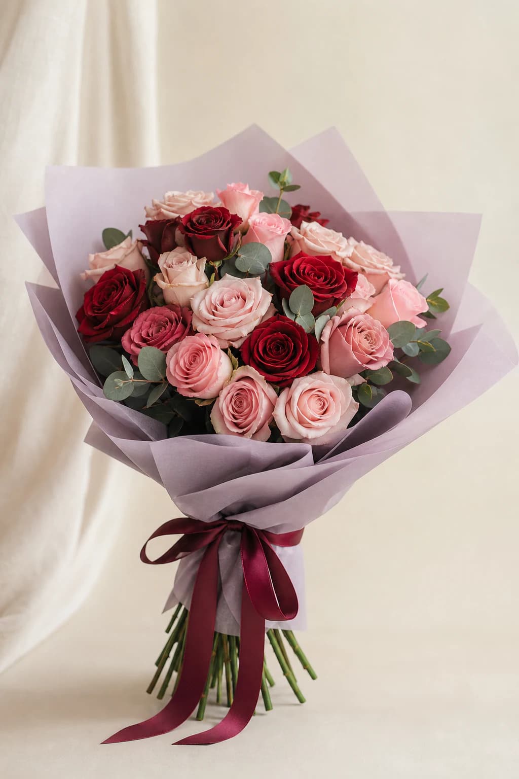 Blush and crimson roses in soft lilac wrapping